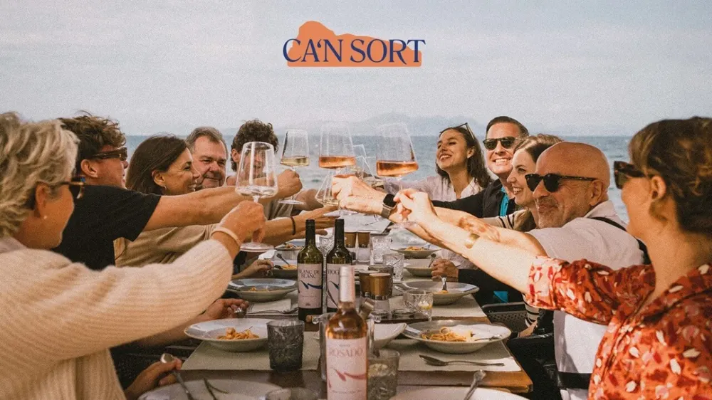 Friends sharing Can Sort wine at a long table