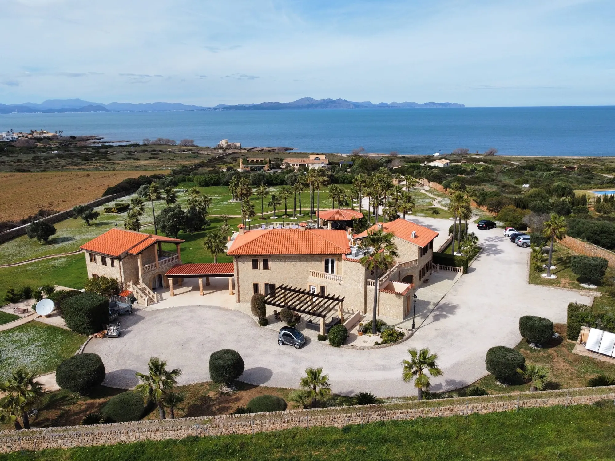 Aerial view of an estate with gardens and sea view
