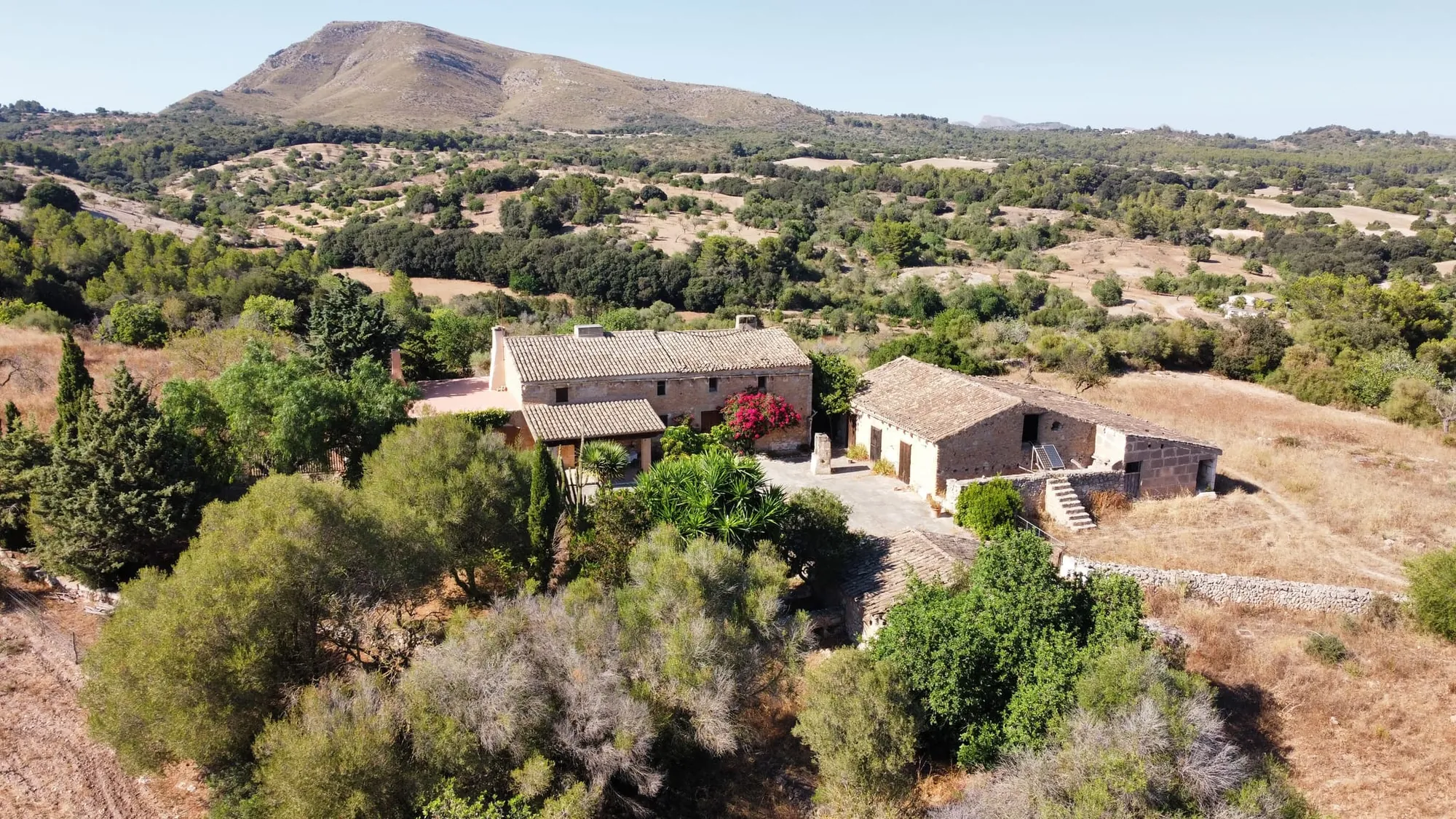 Aerial view of a rural finca below a mountain in Mallorca