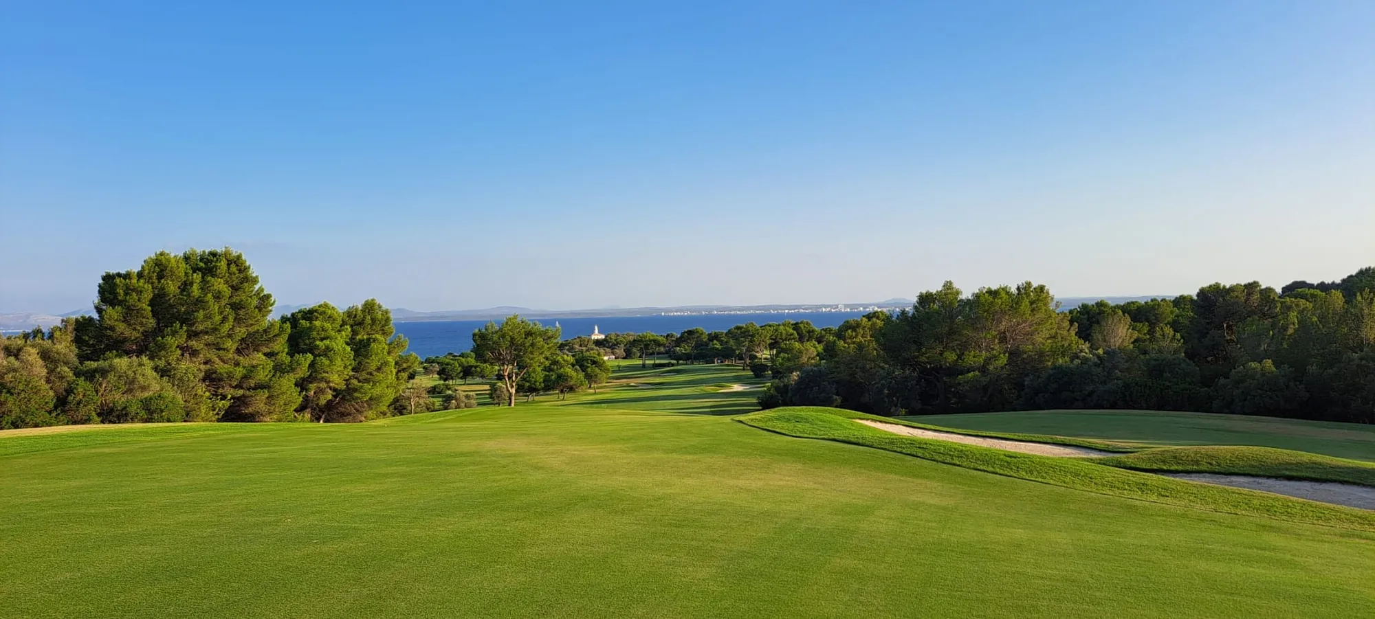 Golf course with the sea on the horizon